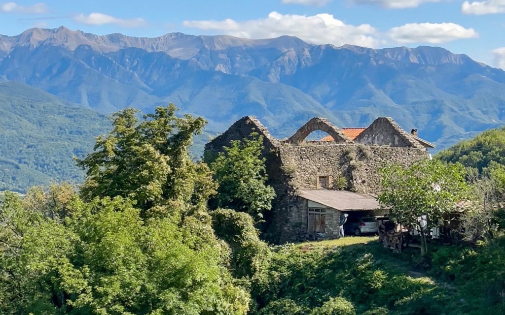 The Oratory of Santa Maria Assunta, the village’s ruined church, with the mountains behind